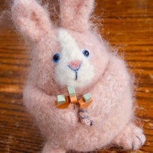 Load image into Gallery viewer, dusty rose fuzzy rabbit pincushion with blue glass eyes, marie mayhew designs, just another button company carrot quilting pins